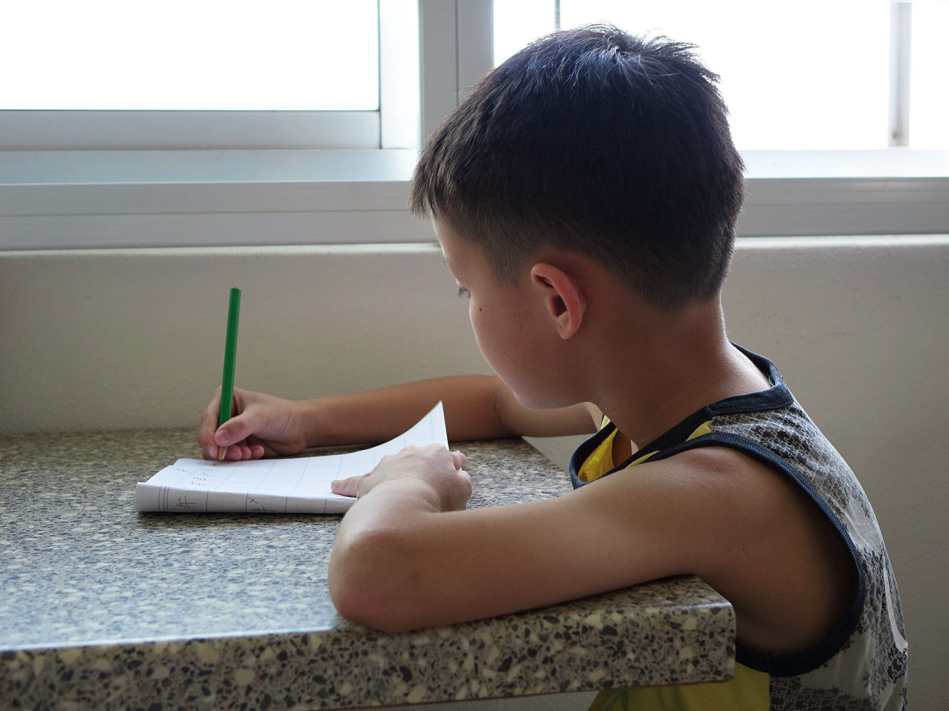 Boy writing at desk