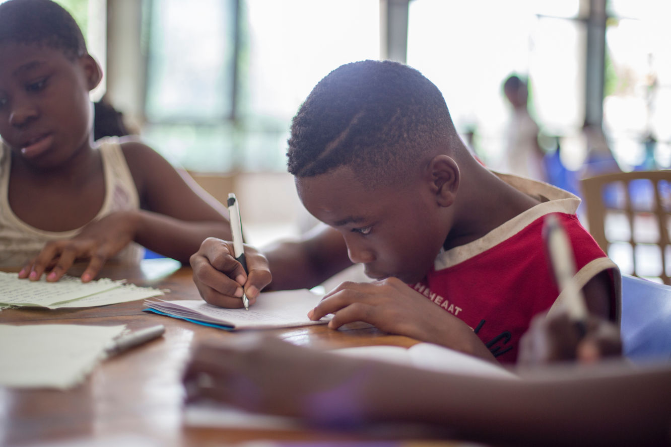 Boy writing at desk
